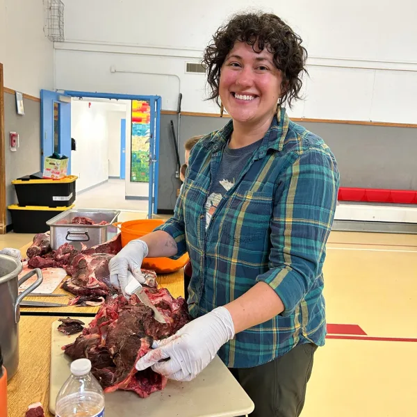 Julie processing caribou at culture camp in Port Heiden during summer 2023.